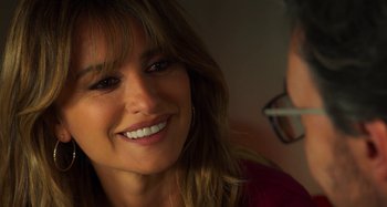 Movie still from “Parallel Mothers” (2021), directed by Pedro Almodóvar – A person with a smile on their face; Close Up shot, Over the shoulder angle