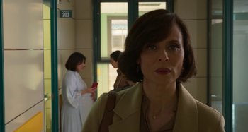 Movie still from “Parallel Mothers” (2021), directed by Pedro Almodóvar – A person standing in front of a window; Close Up shot, Over the shoulder angle