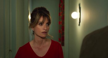 Movie still from “Parallel Mothers” (2021), directed by Pedro Almodóvar – A woman in a red shirt is looking at the camera; Close Up shot, Over the shoulder angle