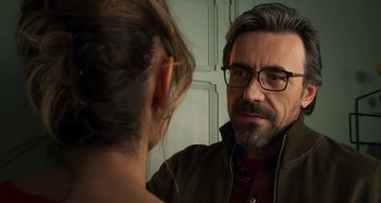 Movie still from “Parallel Mothers” (2021), directed by Pedro Almodóvar – A man looking at a woman in the mirror; Close Up shot, Over the shoulder angle