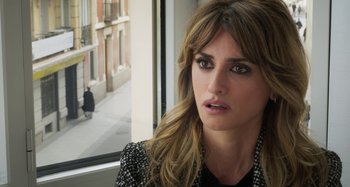 Movie still from “Parallel Mothers” (2021), directed by Pedro Almodóvar – A person looking out a window; Close Up shot, Over the shoulder angle