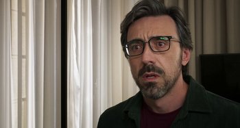 Movie still from “Parallel Mothers” (2021), directed by Pedro Almodóvar – A person wearing glasses; Close Up shot, Over the shoulder angle