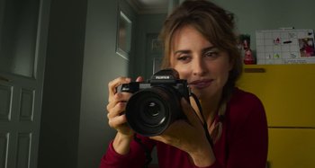 Movie still from “Parallel Mothers” (2021), directed by Pedro Almodóvar – A woman holding a camera taking a picture of herself; Close Up shot, Low angle