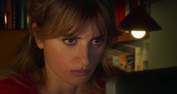 Movie still from “Parallel Mothers” (2021), directed by Pedro Almodóvar – A woman's face as she looks into the camera; Close Up shot, Over the shoulder angle