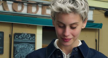 Movie still from “Parallel Mothers” (2021), directed by Pedro Almodóvar – A person wearing a jean jacket; Close Up shot, Low angle