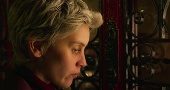 Movie still from “Parallel Mothers” (2021), directed by Pedro Almodóvar – A person with short blonde hair; Close Up shot, Low angle