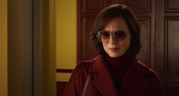 Movie still from “Parallel Mothers” (2021), directed by Pedro Almodóvar – A woman wearing sunglasses and a red coat; Medium shot, Low angle