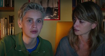 Movie still from “Parallel Mothers” (2021), directed by Pedro Almodóvar – Two people sitting next to each other in a room; Close Up shot, Over the shoulder angle