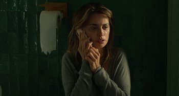 Movie still from “Parallel Mothers” (2021), directed by Pedro Almodóvar – A woman holding a cell phone up to her ear; Close Up shot, High angle