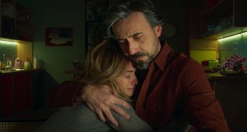 Movie still from “Parallel Mothers” (2021), directed by Pedro Almodóvar – A man and a woman hugging in a living room; Close Up shot, Low angle