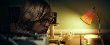 Movie still from “My Friend Dahmer” (2017), directed by Marc Meyers – A person sitting at a table with glasses on their face; Close Up shot, Low angle