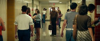 Movie still from “My Friend Dahmer” (2017), directed by Marc Meyers – A group of people standing in a school hallway; Wide shot, Over the shoulder angle