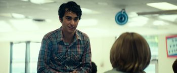 Movie still from “My Friend Dahmer” (2017), directed by Marc Meyers – A man in a plaid shirt sitting in front of a woman; Medium shot, Over the shoulder angle