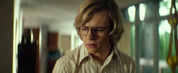 Movie still from “My Friend Dahmer” (2017), directed by Marc Meyers – A man with blonde hair wearing glasses and a striped shirt; Close Up shot, Low angle