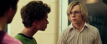 Movie still from “My Friend Dahmer” (2017), directed by Marc Meyers – Two young men standing next to each other in front of a brick wall; Close Up shot, Over the shoulder angle
