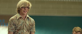 Movie still from “My Friend Dahmer” (2017), directed by Marc Meyers – A man with blonde hair wearing glasses and a button up shirt; Medium shot, Over the shoulder angle