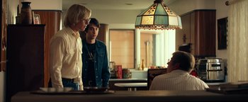 Movie still from “My Friend Dahmer” (2017), directed by Marc Meyers – Two young men standing next to each other in front of a table; Medium shot, Over the shoulder angle