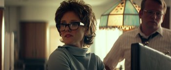 Movie still from “My Friend Dahmer” (2017), directed by Marc Meyers – A woman wearing glasses sitting in front of a lamp; Close Up shot, Over the shoulder angle