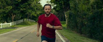 Movie still from “My Friend Dahmer” (2017), directed by Marc Meyers – A man running down the side of a road; Close Up shot, Low angle