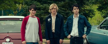 Movie still from “My Friend Dahmer” (2017), directed by Marc Meyers – A group of young men standing next to each other in front of trees; Medium shot, Low angle