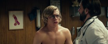 Movie still from “My Friend Dahmer” (2017), directed by Marc Meyers – A shirtless man with glasses looking at the camera; Medium shot, Over the shoulder angle