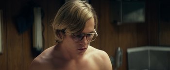 Movie still from “My Friend Dahmer” (2017), directed by Marc Meyers – A man with glasses is looking down at his face; Close Up shot, Low angle