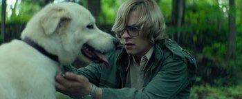 Movie still from “My Friend Dahmer” (2017), directed by Marc Meyers – A young man petting a white dog's face; Close Up shot, Over the shoulder angle