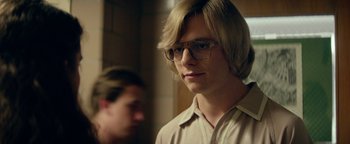 Movie still from “My Friend Dahmer” (2017), directed by Marc Meyers – A man with blonde hair and glasses is looking at the camera; Close Up shot, Over the shoulder angle