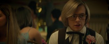 Movie still from “My Friend Dahmer” (2017), directed by Marc Meyers – A man with glasses sitting in front of a table; Close Up shot, Over the shoulder angle