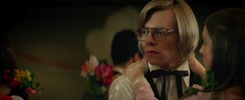 Movie still from “My Friend Dahmer” (2017), directed by Marc Meyers – A man in a bow tie is adjusting his bow tie; Close Up shot, Over the shoulder angle