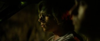 Movie still from “My Friend Dahmer” (2017), directed by Marc Meyers – A person with glasses looking to the side; Close Up shot, Over the shoulder angle