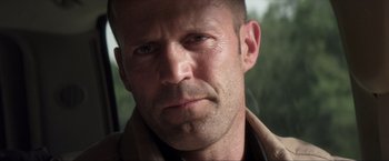 Movie still from “Parker” (2013), directed by Taylor Hackford – A man's face in a car; Close Up shot, Low angle