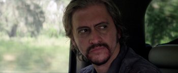 Movie still from “Parker” (2013), directed by Taylor Hackford – A person with a beard; Close Up shot, Over the shoulder angle