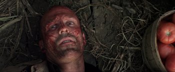 Movie still from “Parker” (2013), directed by Taylor Hackford – A man with blood all over his face and head; Close Up shot, Overhead angle