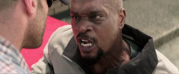 Movie still from “Parker” (2013), directed by Taylor Hackford – A man's face with an angry look; Close Up shot, Low angle