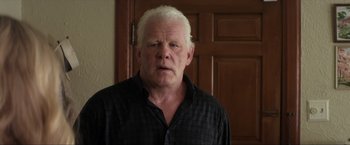 Movie still from “Parker” (2013), directed by Taylor Hackford – An older man with white hair is looking at the camera; Close Up shot, Low angle