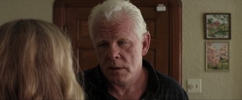 Movie still from “Parker” (2013), directed by Taylor Hackford – An older man with white hair looking at the camera; Close Up shot, Over the shoulder angle