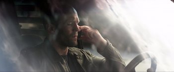 Movie still from “Parker” (2013), directed by Taylor Hackford – A person talking on a cell phone; Close Up shot, Low angle