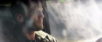 Movie still from “Parker” (2013), directed by Taylor Hackford – A person looking out a window; Close Up shot, Low angle