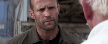 Movie still from “Parker” (2013), directed by Taylor Hackford – A person wearing a jacket; Close Up shot, Over the shoulder angle