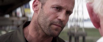 Movie still from “Parker” (2013), directed by Taylor Hackford – A man's face with a beard; Close Up shot, Over the shoulder angle