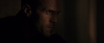 Movie still from “Parker” (2013), directed by Taylor Hackford – A person's face in the dark; Close Up shot, Low angle