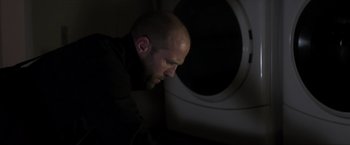 Movie still from “Parker” (2013), directed by Taylor Hackford – A bald man is looking down at his face; Close Up shot, Low angle