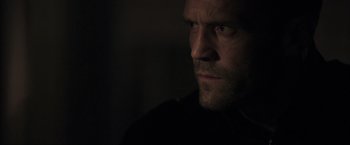 Movie still from “Parker” (2013), directed by Taylor Hackford – A person looking at the camera; Close Up shot, Over the shoulder angle