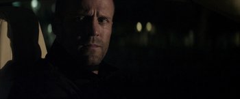 Movie still from “Parker” (2013), directed by Taylor Hackford – A man's face in the dark; Close Up shot, Over the shoulder angle