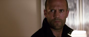 Movie still from “Parker” (2013), directed by Taylor Hackford – A person wearing a black shirt; Close Up shot, Low angle