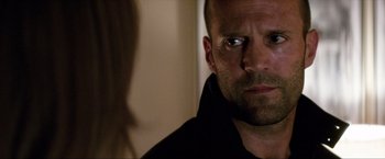 Movie still from “Parker” (2013), directed by Taylor Hackford – A person looking at the camera; Close Up shot, Over the shoulder angle