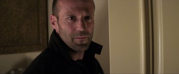 Movie still from “Parker” (2013), directed by Taylor Hackford – A person wearing a black jacket; Close Up shot, Low angle