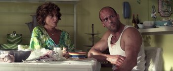 Movie still from “Parker” (2013), directed by Taylor Hackford – A man and a woman sitting at a dinner table; Medium shot, Over the shoulder angle