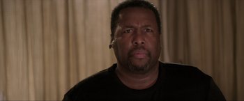 Movie still from “Parker” (2013), directed by Taylor Hackford – A person wearing a black t - shirt; Close Up shot, Over the shoulder angle